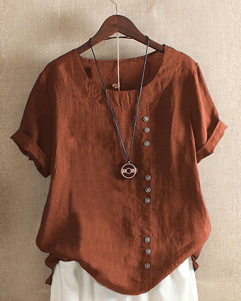 Close-up of a women's short sleeve top with functional button front and crew neck detail.