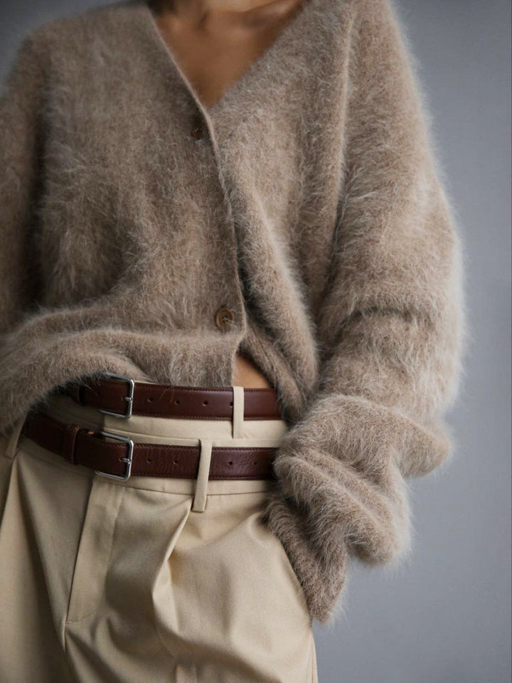 Model smiling while wearing a comfortable women's oversized cardigan, radiating warmth