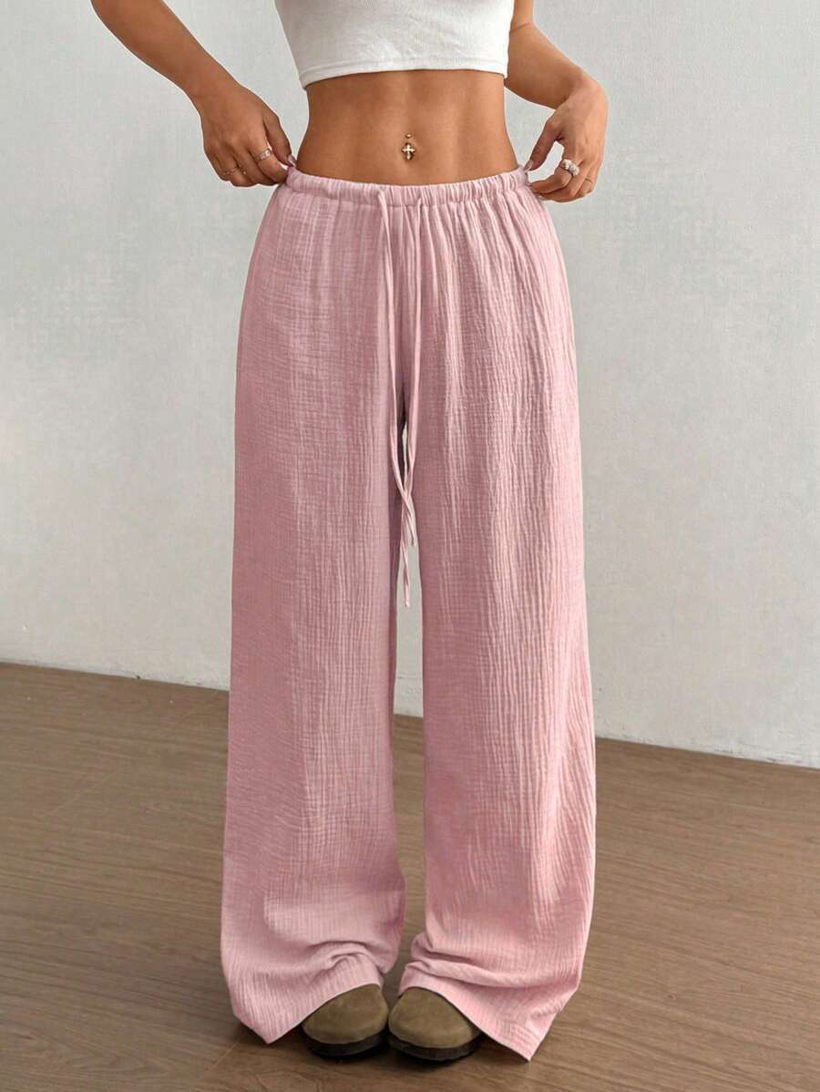 Women's crinkle wide leg pants with drawstring waist for comfortable summer casual wear.