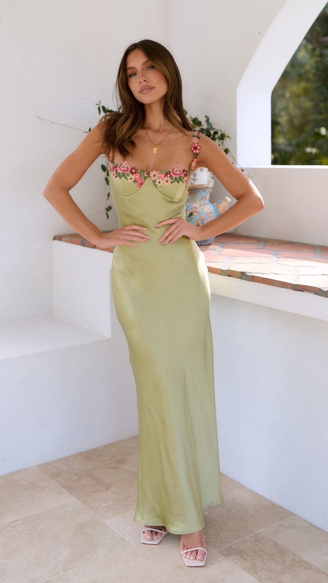Women's sleeveless floral maxi dress, slim strap design, offering a stylish summer look.