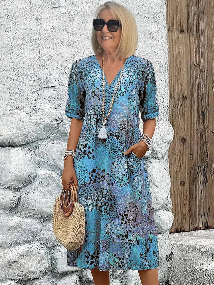 Close-up of the delicate floral print on a women's V-neck midi dress. Elegant and versatile for summer occasions.