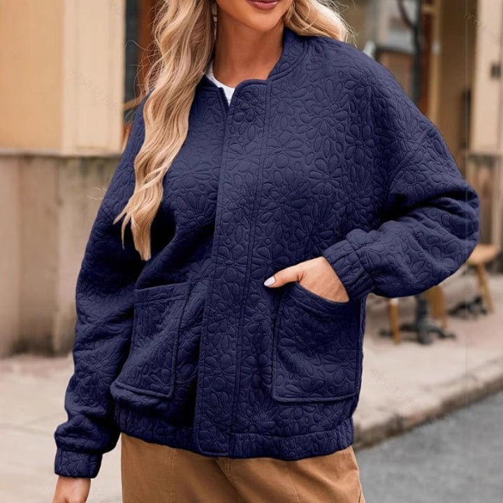 Zip-up women's padded jacket, lightweight and quilted, suitable for fall fashion and everyday casual wear.