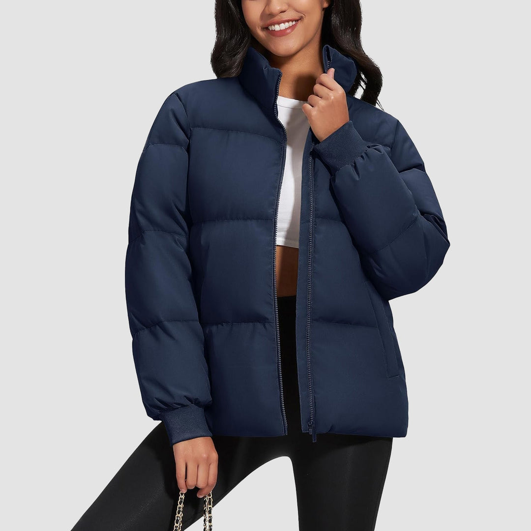 Folded black women's puffer jacket, lightweight and compact for travel, insulated