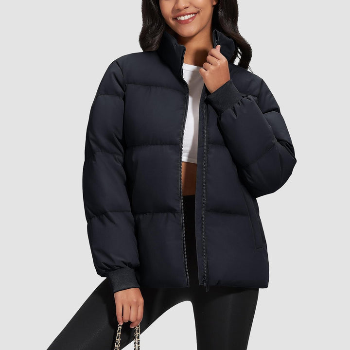 Detail of zipper and collar on a black quilted women's winter coat, stylish and warm
