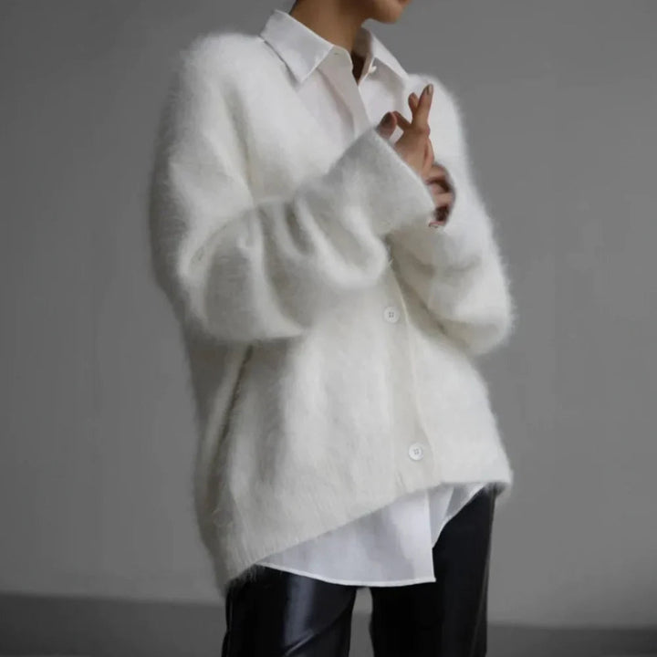 Close-up of a women's knit open front cardigan, showcasing the soft texture of mohair and wool
