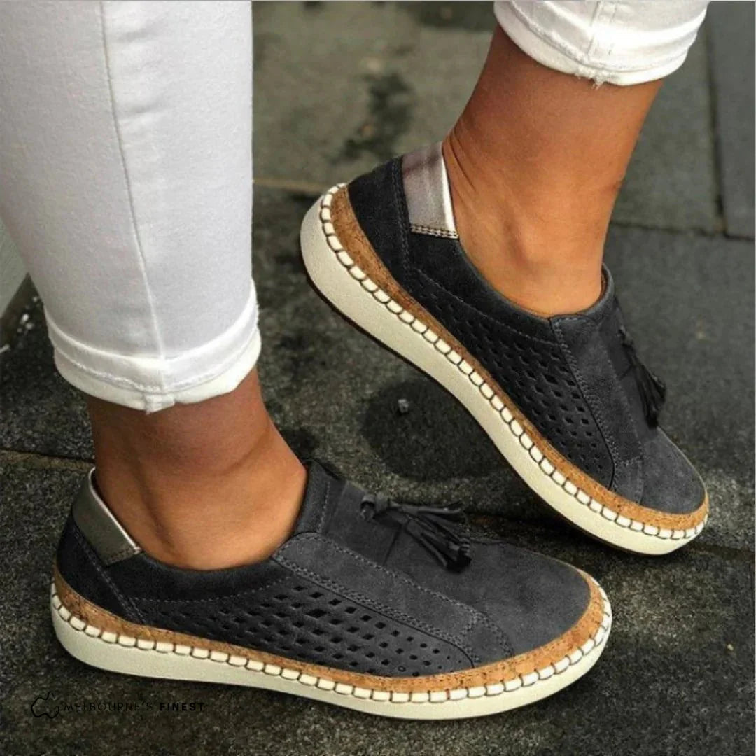 Stylish women's slip-on loafers with perforated design, perfect for spring and summer casual footwear.