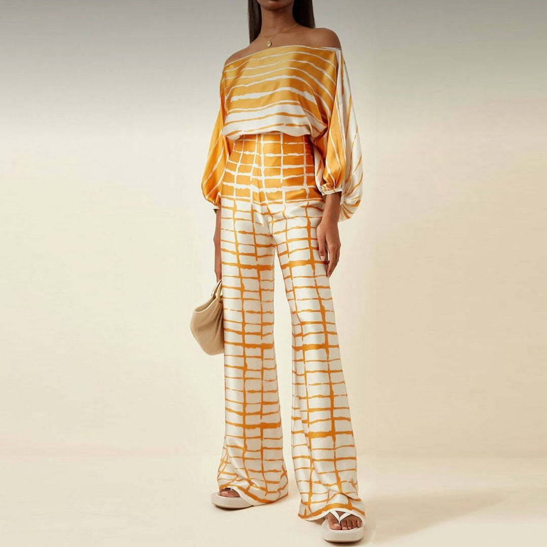 Vacation-ready women's printed one-shoulder co-ord set with flowy wide-leg pants. Casual chic fashion.