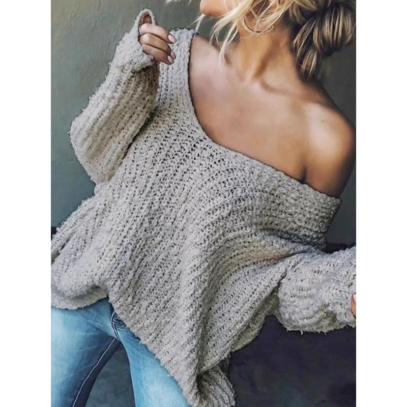 Close-up of the woven texture on a women's knit V-neck sweater, showcasing quality.
