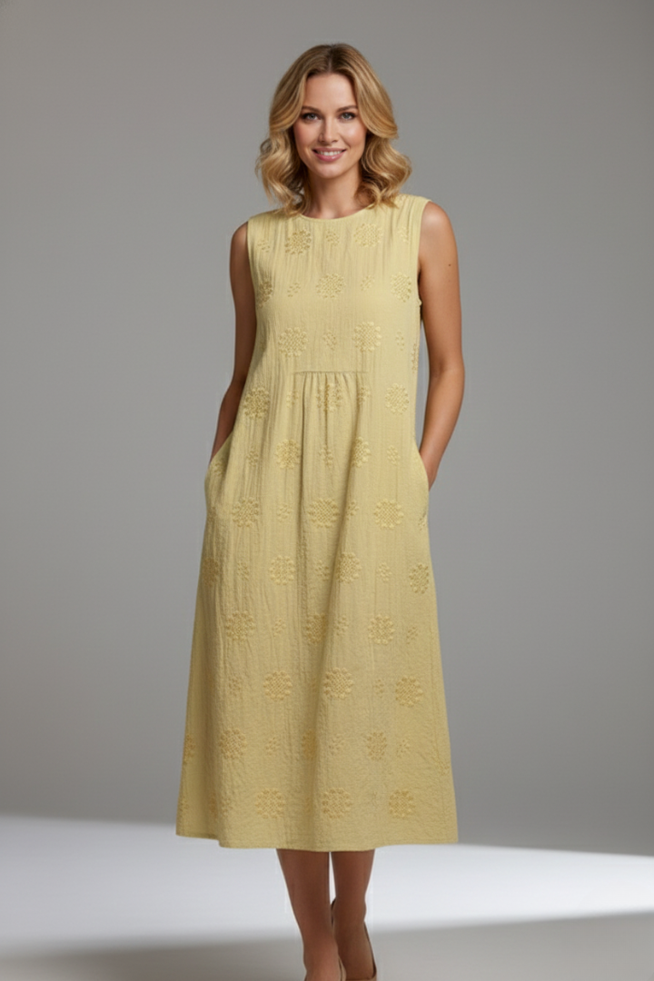 Model wearing women's textured sleeveless midi dress with pockets, round neck, ideal for summer.