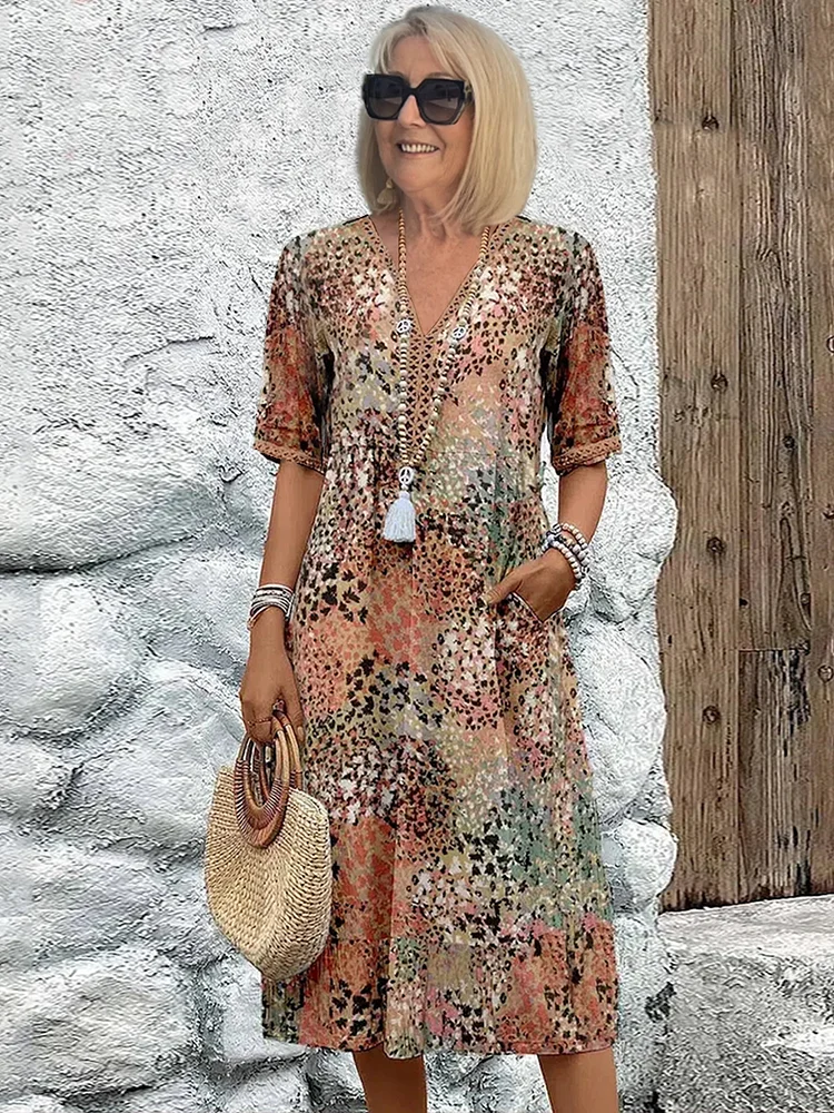 Elegant women's vibrant print midi dress, a flowy sleeveless design for comfortable summer party wear.