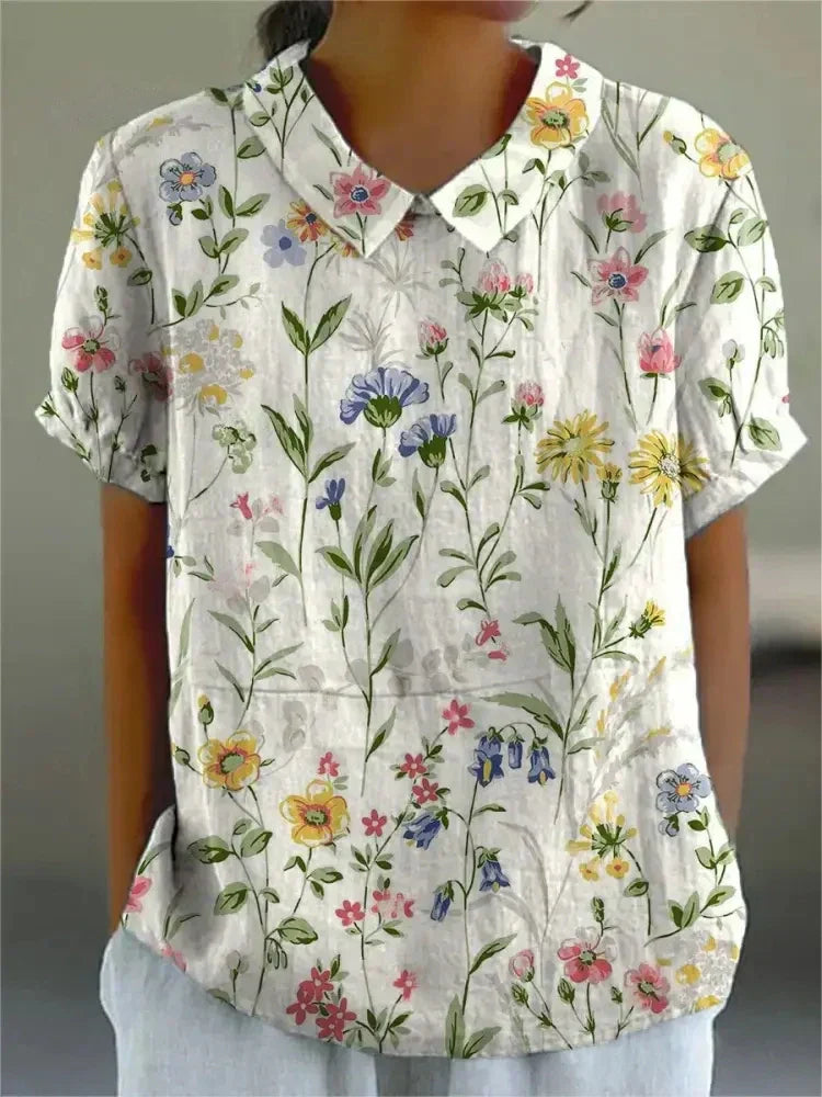 Women's blouse with short gathered sleeves, pointed collar, relaxed fit, perfect for spring-summer style and comfort.