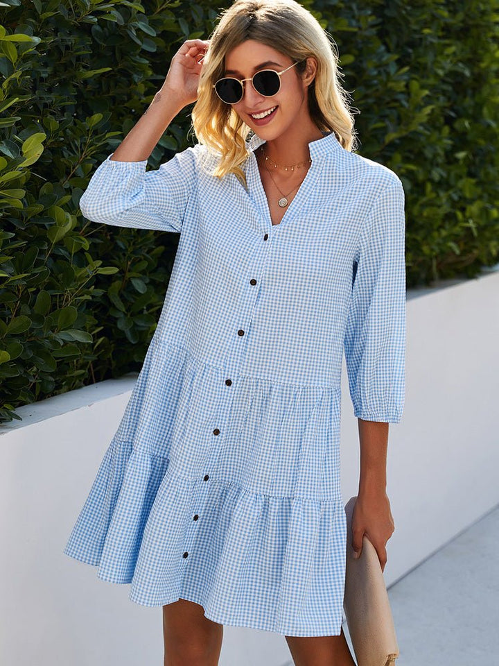 Women's blue gingham summer dress with a classic pattern, lightweight fabric, and flattering fit for sunny day outings.