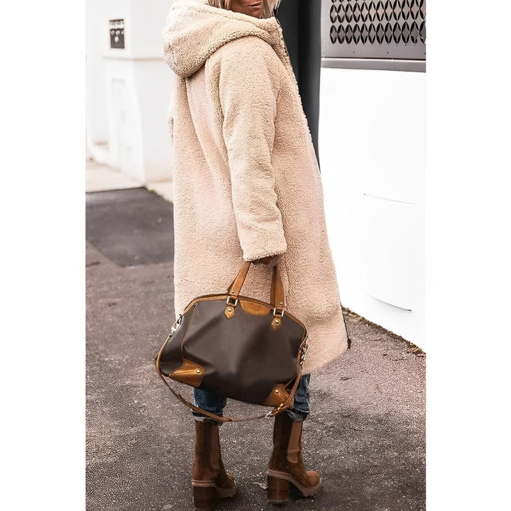"Women's hooded longline quilted winter coat, front view; insulated, open front design with quilted texture and hood."