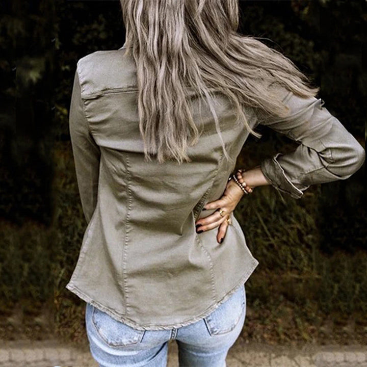 Women's lightweight denim shirt jacket with button front, structured silhouette, and chest pockets for a casual chic look.