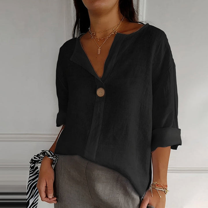 "Women's linen V-neck blouse with rolled sleeves, featuring a relaxed fit and soft breathable fabric."