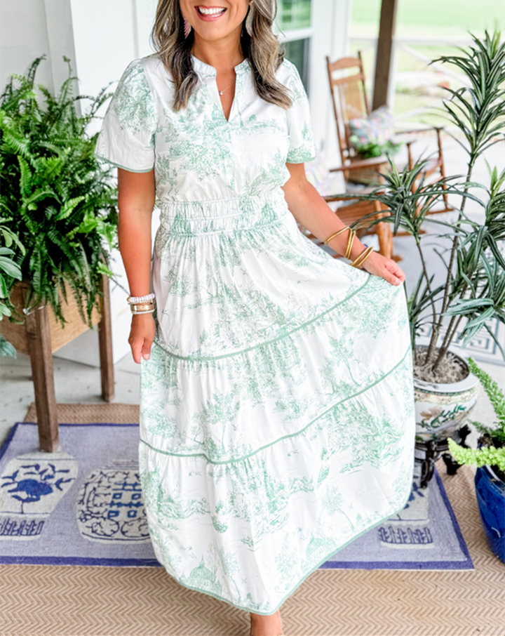 Women's toile print maxi dress with puff sleeves, showcases vintage charm with a scenic motif and fitted silhouette.