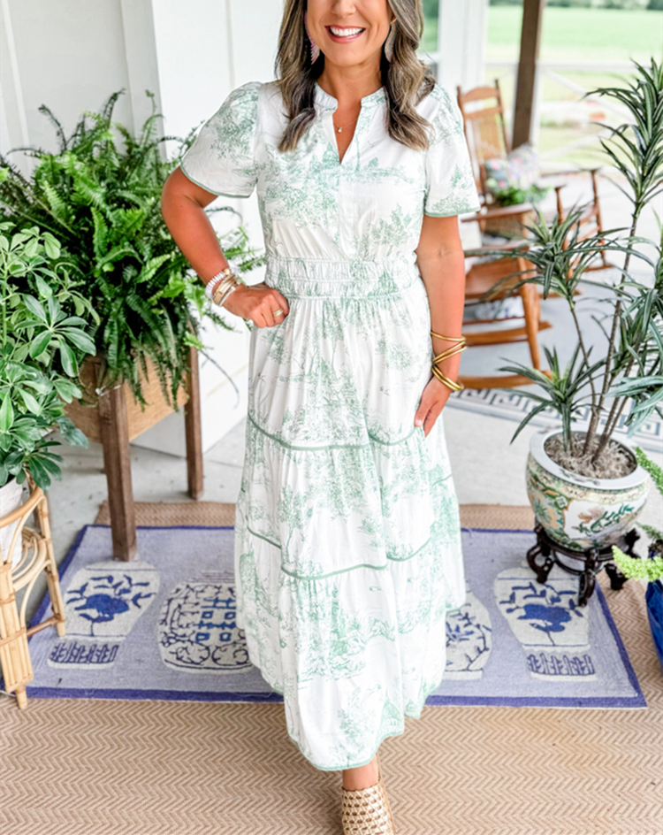 Women's toile print maxi dress with puff sleeves, showcases vintage charm with a scenic motif and fitted silhouette.